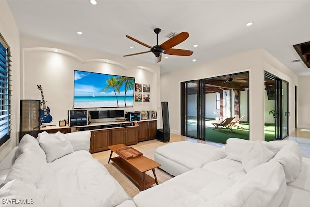 living area featuring baseboards, a ceiling fan, and recessed lighting