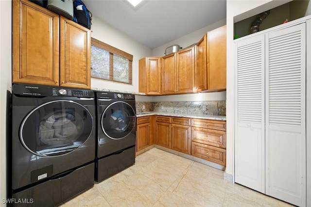 washroom featuring separate washer and dryer and cabinet space