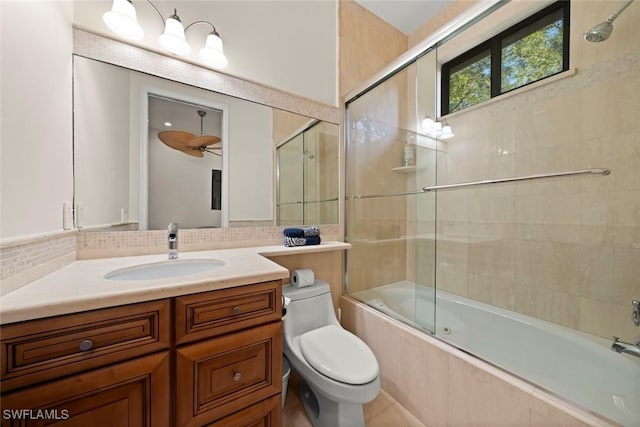 full bath featuring vanity, tiled shower / bath, and toilet