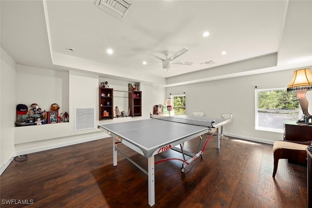 recreation room featuring a tray ceiling, visible vents, and plenty of natural light