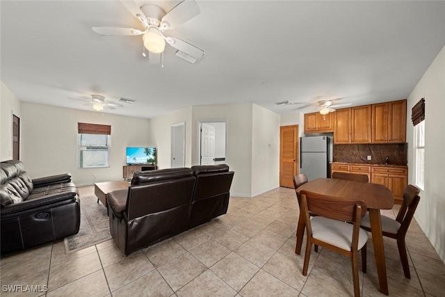 living room featuring a ceiling fan and light tile patterned floors