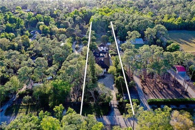 birds eye view of property with a view of trees