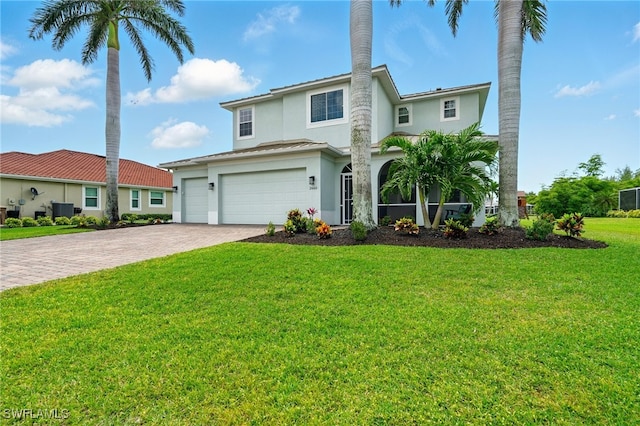 traditional-style home with stucco siding, decorative driveway, a garage, central AC, and a front lawn