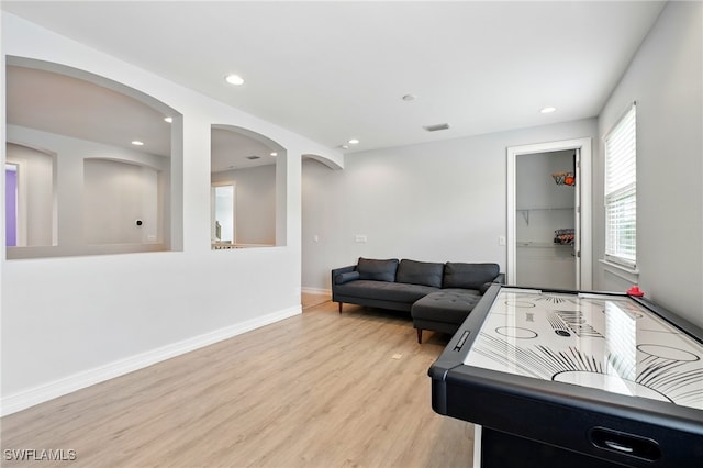 recreation room with wood finished floors, recessed lighting, visible vents, and baseboards