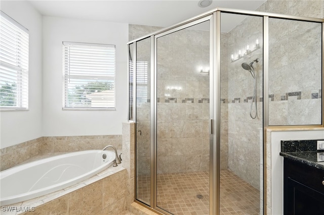 full bath featuring a garden tub, a shower stall, and vanity
