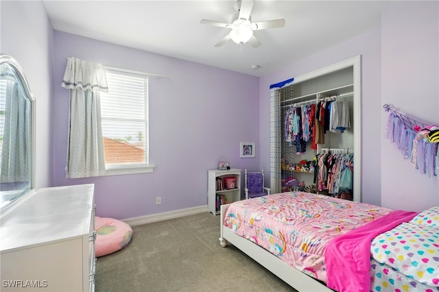 bedroom with a closet, a ceiling fan, carpet floors, and baseboards