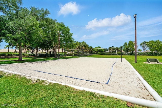 surrounding community with volleyball court and a lawn