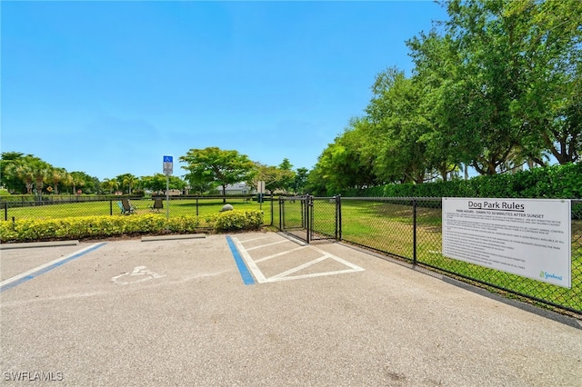 uncovered parking lot with a gate and fence