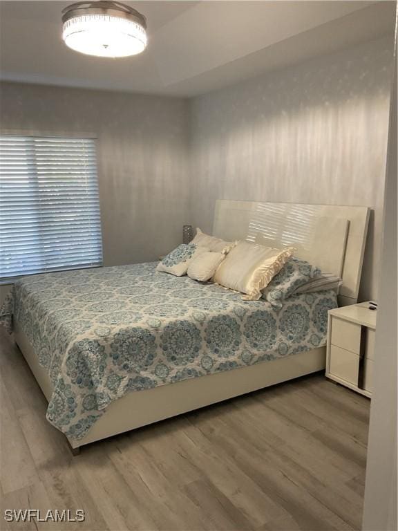 bedroom with wood finished floors
