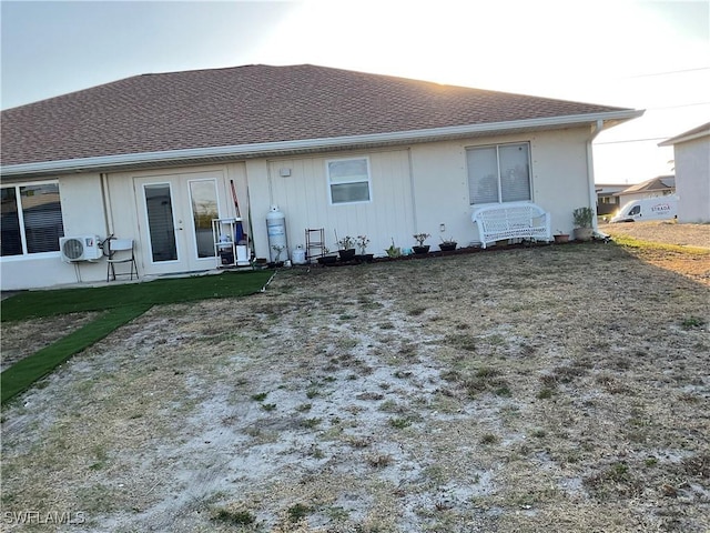 back of house featuring french doors and ac unit