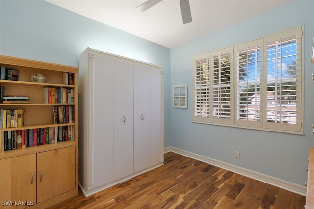 bedroom featuring baseboards, ceiling fan, a closet, and wood finished floors