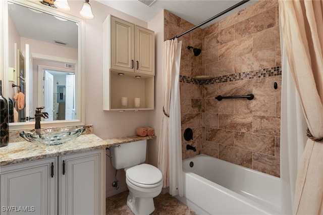 bathroom featuring vanity, toilet, visible vents, and shower / tub combo