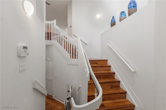 stairway with wood finished floors