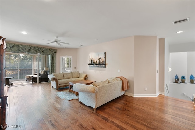 living area with ceiling fan, visible vents, wood finished floors, baseboards, and recessed lighting