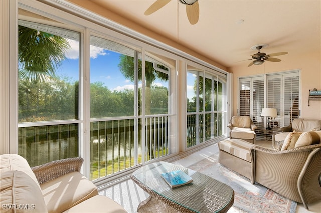 sunroom / solarium with a water view
