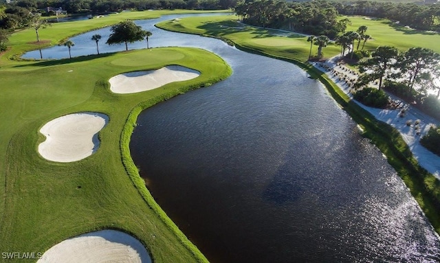 bird's eye view with a water view and view of golf course