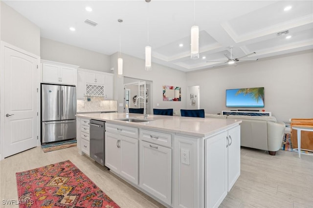 16166 Herons View Dr, Alva, FL 33920 - kitchen featuring a kitchen island with sink, a ceiling fan, appliances with stainless steel finishes, a sink, and white cabinetry
