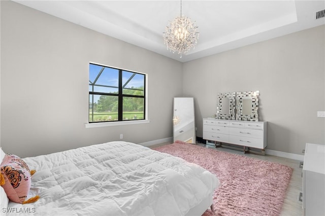 16166 Herons View Dr, Alva, FL 33920 - bedroom featuring a raised ceiling, baseboards, a chandelier, and visible vents