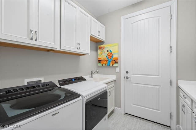 16166 Herons View Dr, Alva, FL 33920 - clothes washing area with baseboards, a sink, cabinet space, and independent washer and dryer