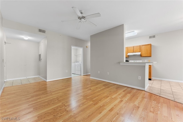 7940 Preserve Cir Unit 914, Naples, FL 34119 - unfurnished living room with independent washer and dryer, light wood finished floors, ceiling fan, and baseboards