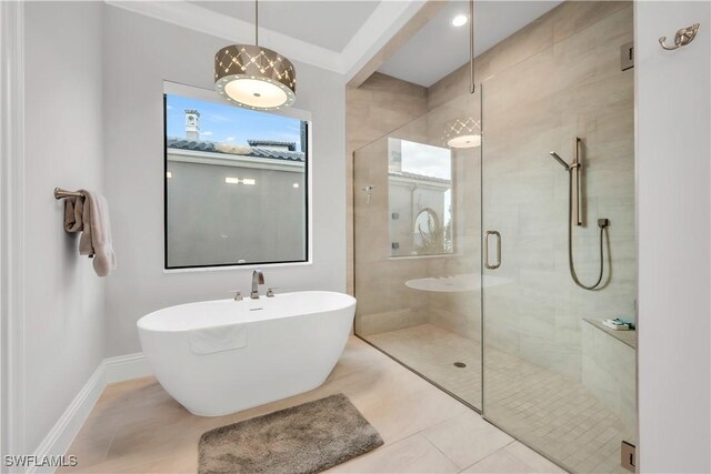 3924 W Riverside Dr, Fort Myers, FL 33901 - bathroom featuring baseboards, a soaking tub, tile patterned flooring, and a stall shower
