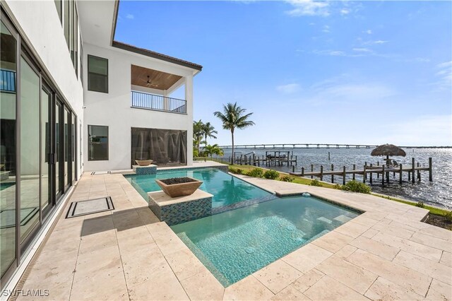 3924 W Riverside Dr, Fort Myers, FL 33901 - view of pool with a patio, a dock, a ceiling fan, a water view, and a pool with connected hot tub