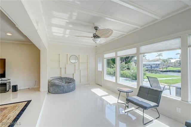sunroom with beamed ceiling and a water view