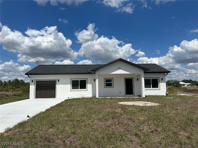 961 Countess Ave, Lehigh Acres, FL 33974 - view of front facade featuring an attached garage, stucco siding, driveway, and a front yard