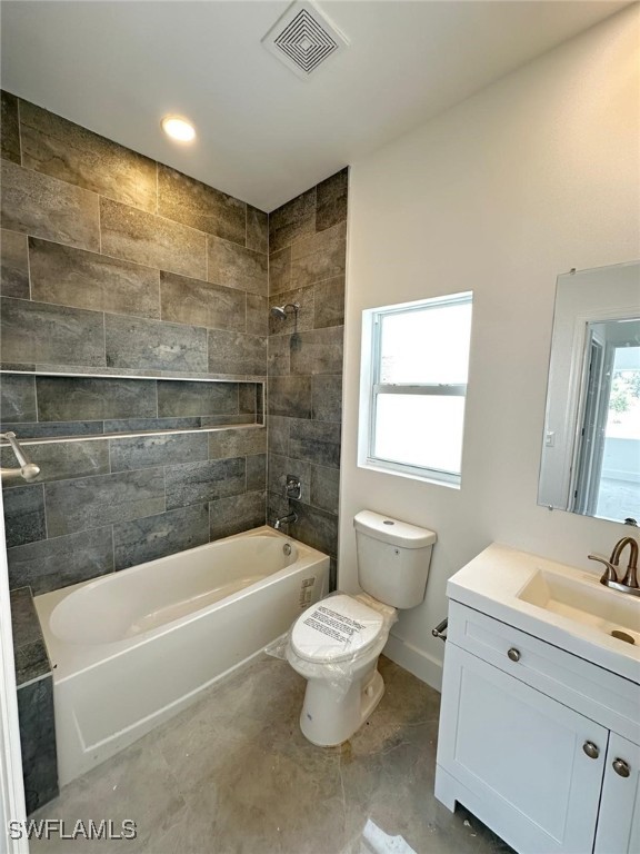 961 Countess Ave, Lehigh Acres, FL 33974 - bathroom with toilet, bathtub / shower combination, vanity, and baseboards