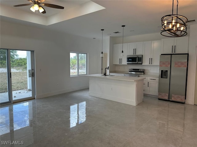 961 Countess Ave, Lehigh Acres, FL 33974 - kitchen with appliances with stainless steel finishes, a sink, baseboards, a ceiling fan, and a chandelier