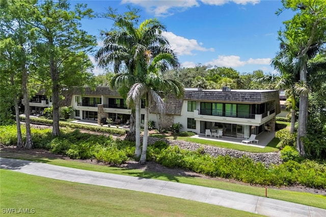 105 Wilderness Dr Unit B105, Naples, FL 34105 - back of property featuring a balcony