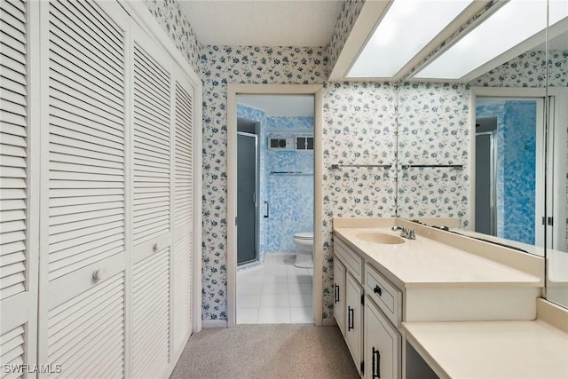 105 Wilderness Dr Unit B105, Naples, FL 34105 - bathroom featuring tile patterned flooring, a closet, toilet, and wallpapered walls