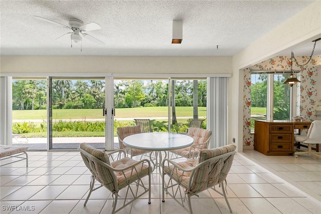 105 Wilderness Dr Unit B105, Naples, FL 34105 - sunroom featuring outdoor dining space, a textured ceiling, ceiling fan, and tile patterned floors