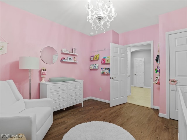 26480 Chaparel Dr, Bonita Springs, FL 34135 - bedroom featuring baseboards, a notable chandelier, and wood finished floors