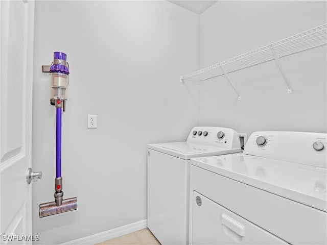 26480 Chaparel Dr, Bonita Springs, FL 34135 - laundry room with separate washer and dryer, baseboards, laundry area, and light tile patterned flooring