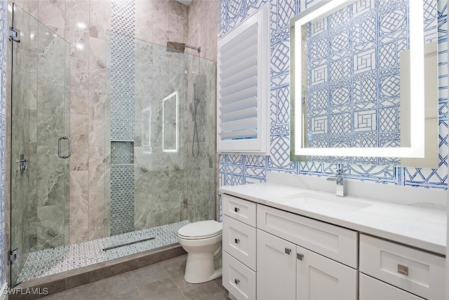 188 W St, Naples, FL 34108 - bathroom with a shower stall, toilet, vanity, and tile patterned floors