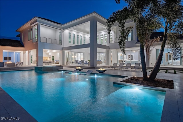 188 W St, Naples, FL 34108 - pool at twilight featuring an outdoor living space, a patio area, and an outdoor pool