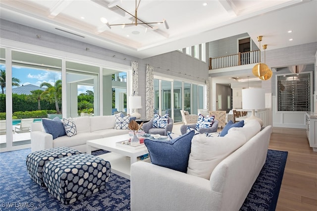 188 W St, Naples, FL 34108 - living area featuring coffered ceiling, a chandelier, wood finished floors, beam ceiling, and a towering ceiling