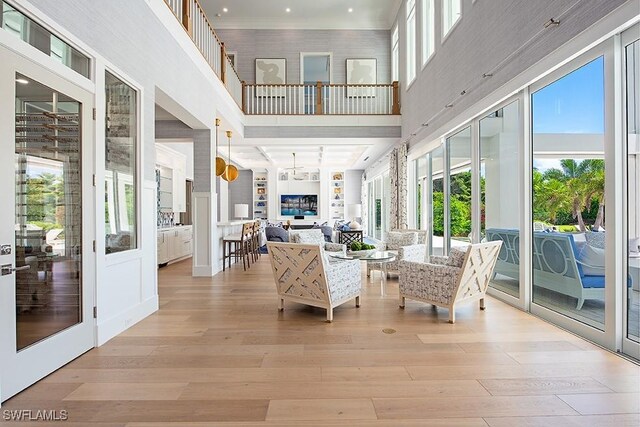 188 W St, Naples, FL 34108 - living area featuring a towering ceiling and light wood-style flooring