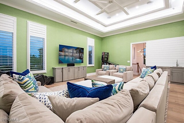 188 W St, Naples, FL 34108 - living room featuring ornamental molding, wood finished floors, ceiling fan, and coffered ceiling