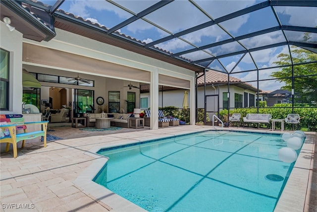 pool with outdoor lounge area, a patio area, ceiling fan, and glass enclosure