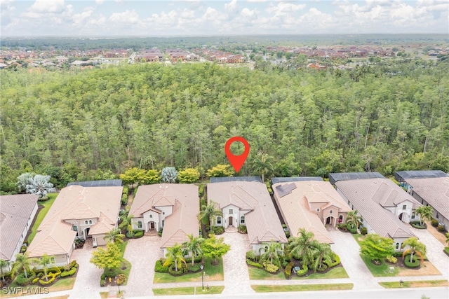 birds eye view of property featuring a view of trees and a residential view