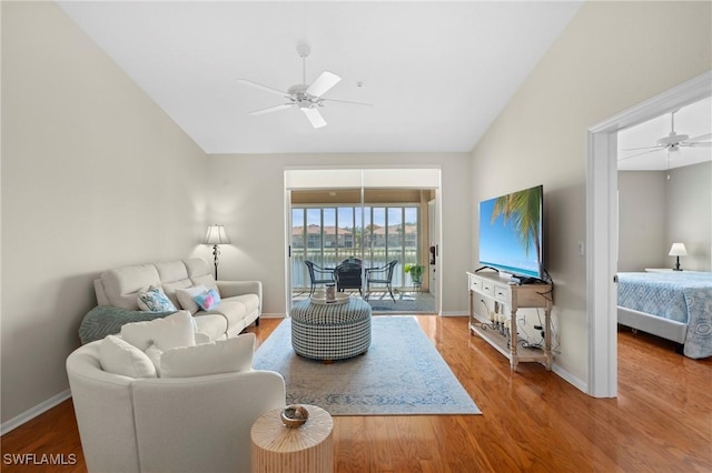 6660 Huntington Lakes Cir Unit 204, Naples, FL 34119 - living room featuring baseboards, a ceiling fan, vaulted ceiling, and wood finished floors