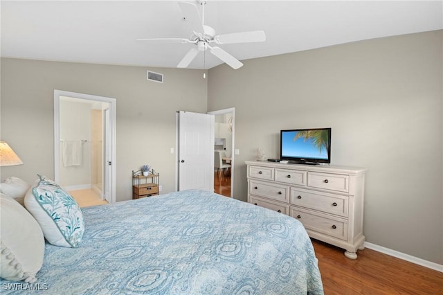 6660 Huntington Lakes Cir Unit 204, Naples, FL 34119 - bedroom with visible vents, wood finished floors, baseboards, a ceiling fan, and vaulted ceiling