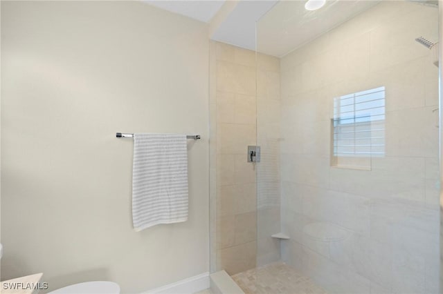 6660 Huntington Lakes Cir Unit 204, Naples, FL 34119 - full bathroom featuring toilet, baseboards, and tiled shower
