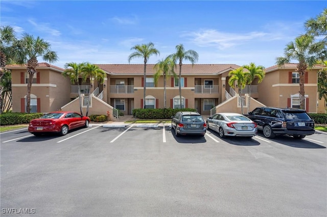 6660 Huntington Lakes Cir Unit 204, Naples, FL 34119 - view of building exterior with uncovered parking and stairway