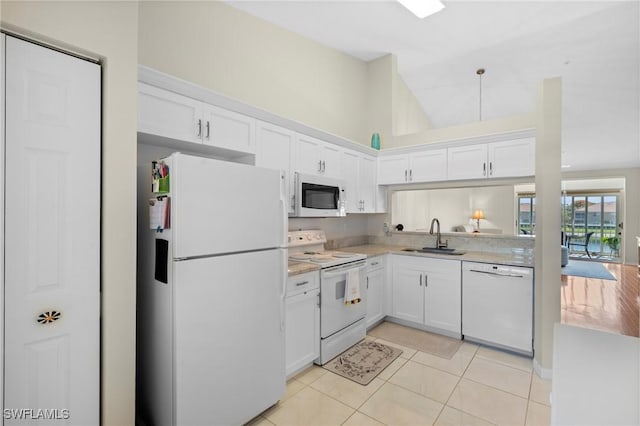 6660 Huntington Lakes Cir Unit 204, Naples, FL 34119 - kitchen with a sink, white cabinets, white appliances, and light countertops
