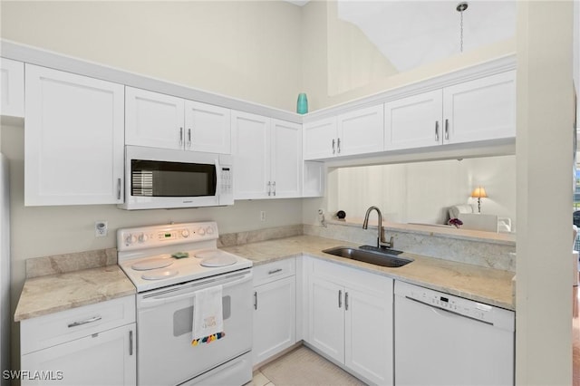 6660 Huntington Lakes Cir Unit 204, Naples, FL 34119 - kitchen with white appliances, white cabinetry, light stone counters, and a sink