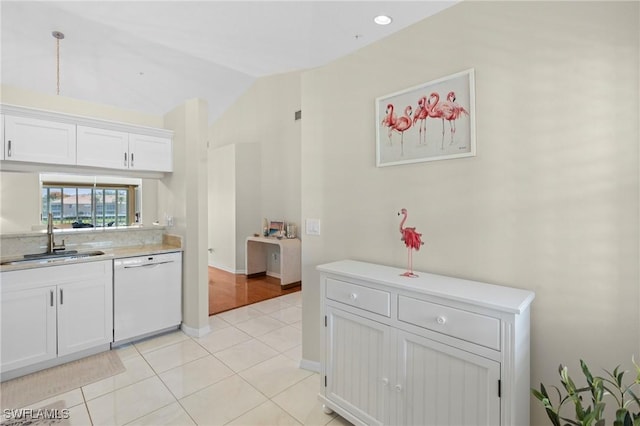 6660 Huntington Lakes Cir Unit 204, Naples, FL 34119 - kitchen featuring white cabinets, a sink, dishwasher, light countertops, and vaulted ceiling