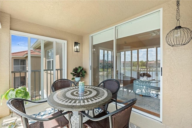 6660 Huntington Lakes Cir Unit 204, Naples, FL 34119 - sunroom with a textured wall, a water view, a healthy amount of sunlight, and ceiling fan